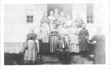 SA1708.51 - Photo shows children and adults on the steps of a building.